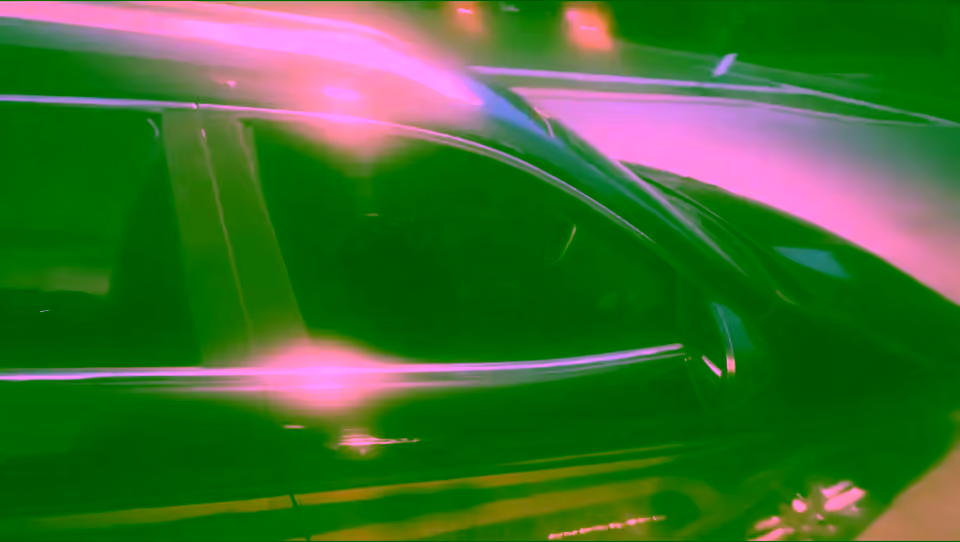 Dark SUV with tinted windows under evening street lights