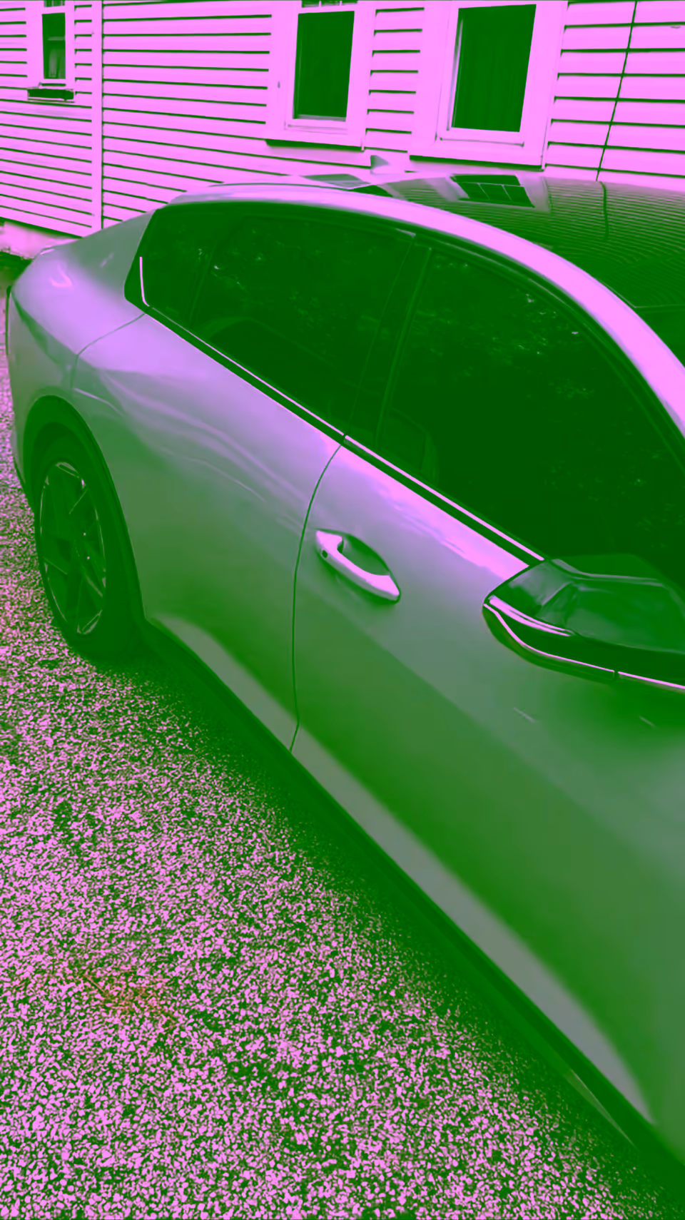 Mint green sports sedan with dark ceramic tint all around